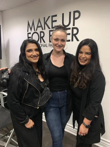 Natalie with two people on set inside a beauty brand's studio, between setups