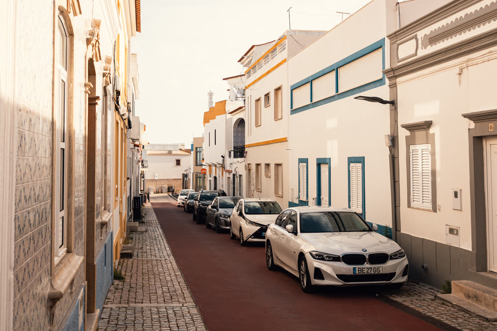 Quiet tiled street outside the property in late sun